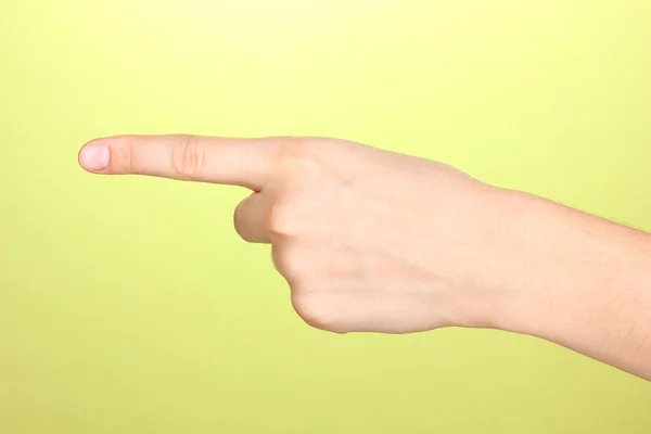 Mão fazendo sinal no fundo verde — Fotografia de Stock