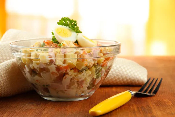 Russian traditional salad Olivier,  on wooden  table, on bright background — Stock Photo, Image