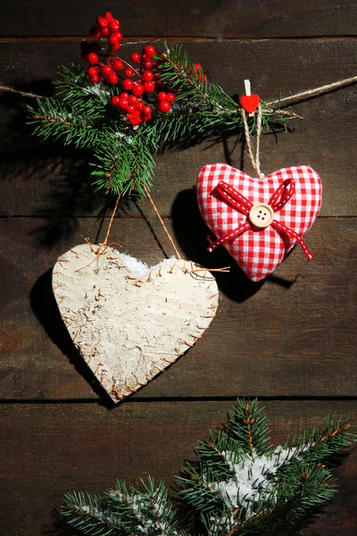 Decorative hearts on rope, on wooden background — Stock Photo, Image