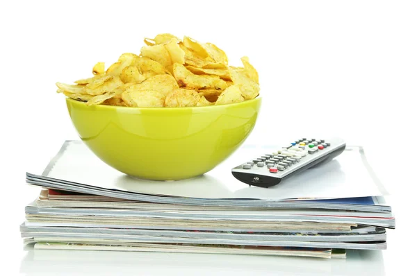 Chips in bowl and TV remote isolated on white — Stock Photo, Image