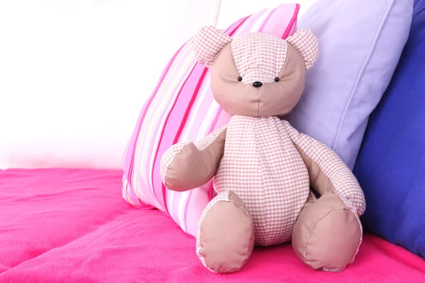 Bear speelgoed met kussens op sofa — Stockfoto