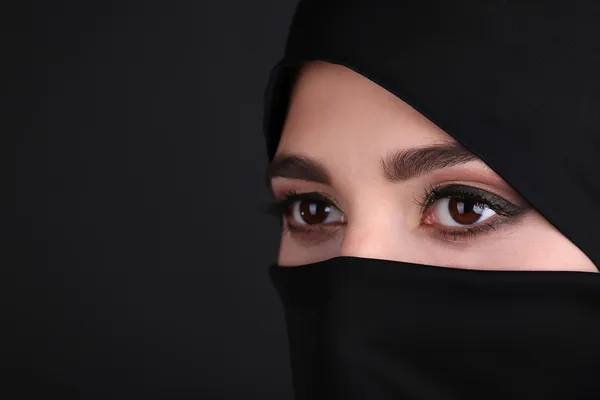 Mooie islamitische Arabische vrouw in paranja op donkere achtergrond — Stockfoto