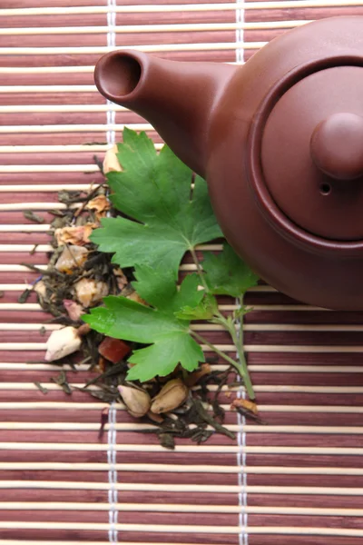 Infusão de chá floral natural de ervas com ingredientes de flores secas, em fundo de tapete de bambu — Fotografia de Stock