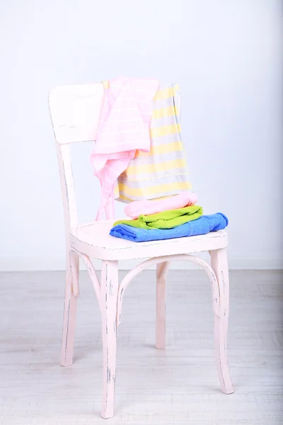Clothes on chair on gray background — Stock Photo, Image