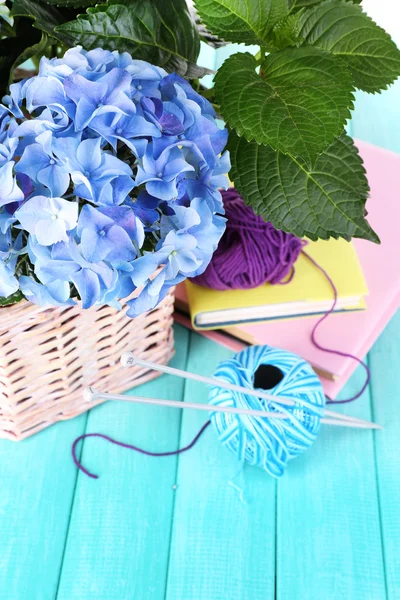 Hydrangea with books and threads on table close-up — Stock Photo, Image