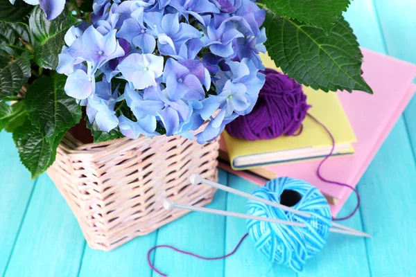 Hydrangea with books and threads on table close-up — Stock Photo, Image