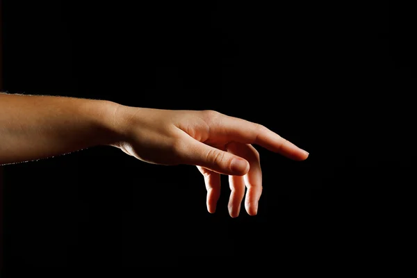 Human hand on black background — Stock Photo, Image
