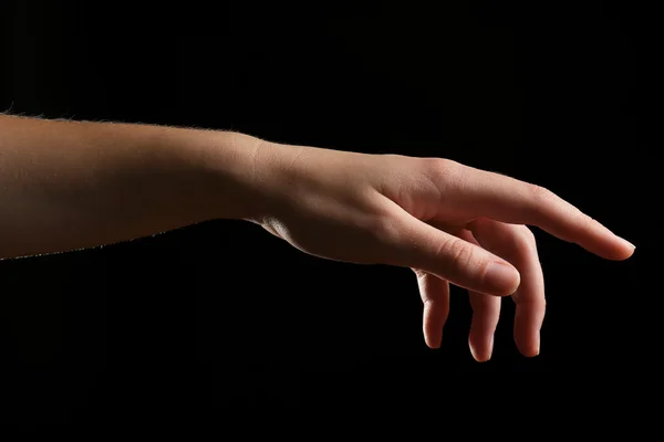 Ludzka ręka na czarnym tle — Zdjęcie stockowe