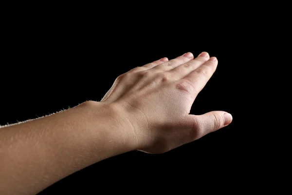 Human hand on black background — Stock Photo, Image