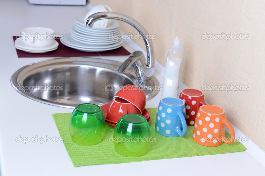 Dishes drying near  metal sink