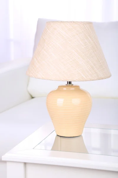 Lamp on coffee table in room — Stock Photo, Image