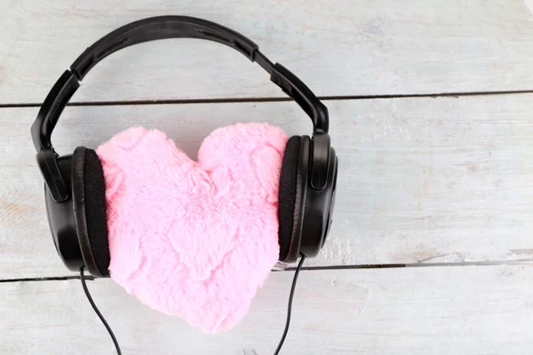 Headphones and heart on wooden background — Stock Photo, Image