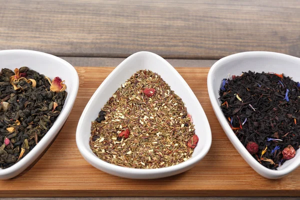 Assortment of dry tea on wooden table — Stock Photo, Image