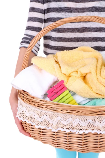 Donna che tiene il cesto della lavanderia con vestiti puliti, asciugamani e spilli, isolati su bianco — Foto Stock