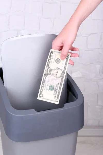 Throwing away your money on grey wall background — Stock Photo, Image