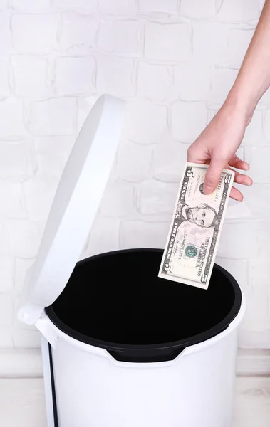 Throwing away your money on grey wall background — Stock Photo, Image