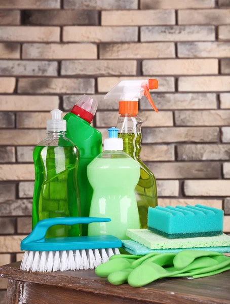 Cleaning products on shelf on bricks wall background — Stock Photo, Image