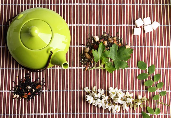 Травяной натуральный цветочный чай с ингредиентами сухих цветов, на бамбуковом фоне мат — стоковое фото