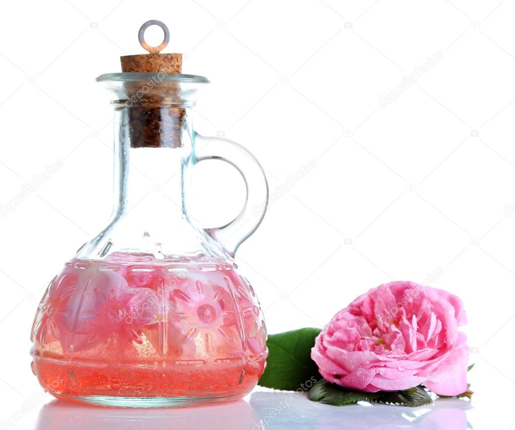Rose oil in bottle isolated on white