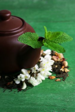 Bitkisel doğal çiçek çay infüzyonu ile renk ahşap arka plan üzerinde kuru çiçekler ve bitkiler malzemeler