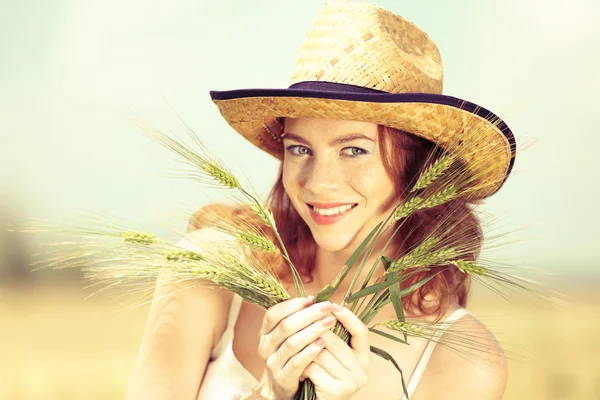 Beautiful young woman with ears in field — Stock Photo, Image