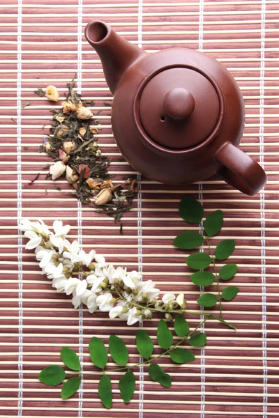 Herbal natural floral tea infusion with dry flowers ingredients, on bamboo mat background — Stock Photo, Image