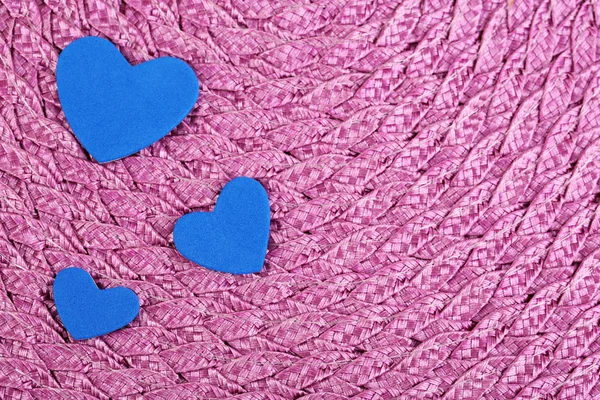 Blue hearts made of felt on purple background — Stock Photo, Image