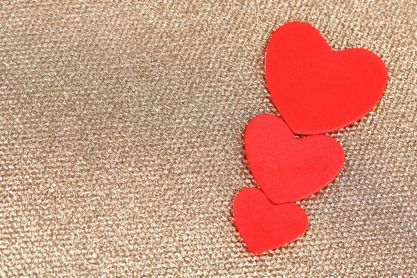 Hearts made of felt on golden background — Stock Photo, Image