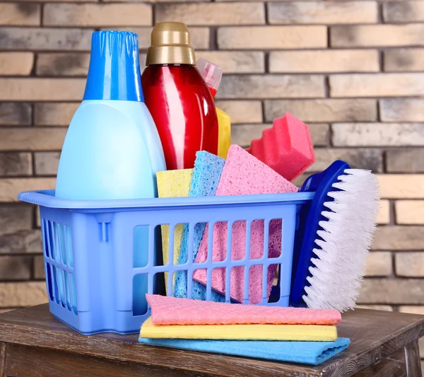 Cleaning products on shelf on bricks wall background — Stock Photo, Image