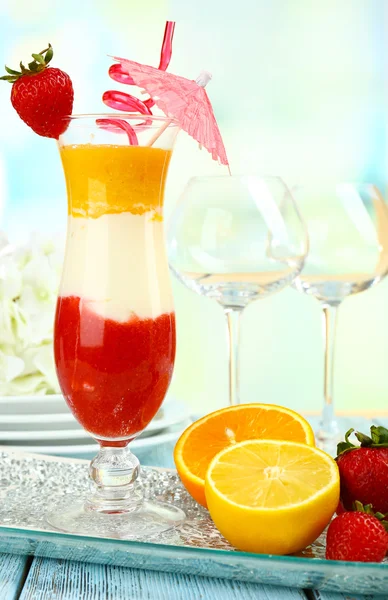 Delicious fruit smoothie on wooden table on light background — Stock Photo, Image