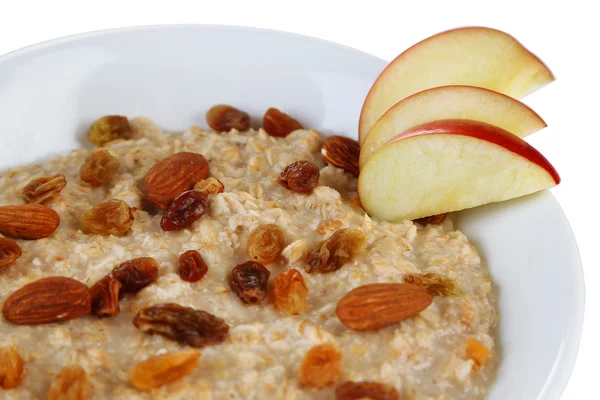 Tasty oatmeal with raisins and apples close up — Stock Photo, Image