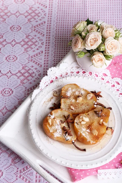 Baked pears with syrup on plate, on bright background — Stock Photo, Image