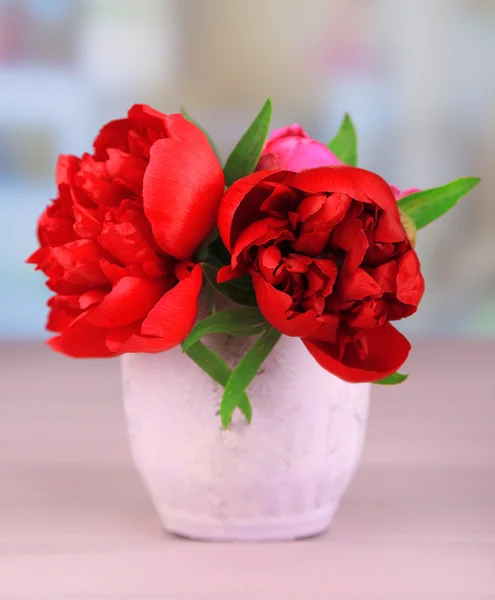 Beautiful pink peonies in vase on light background — Stock Photo, Image