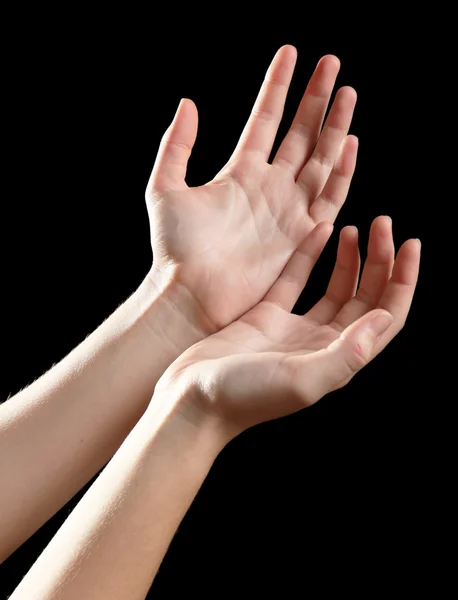 Lidské ruce na černém pozadí — Stock fotografie