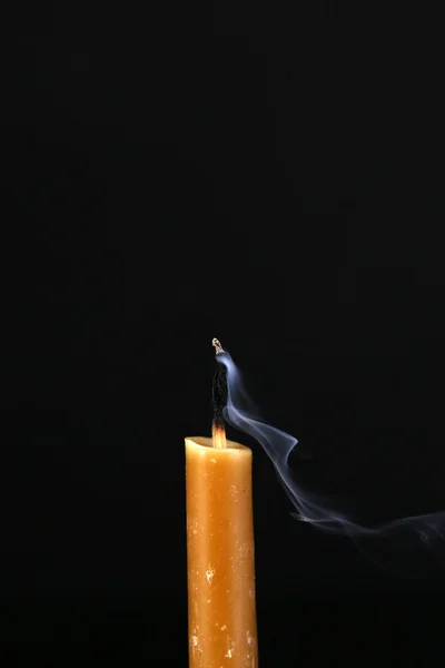 Extinguished candle with smoke on black background — Stock Photo, Image