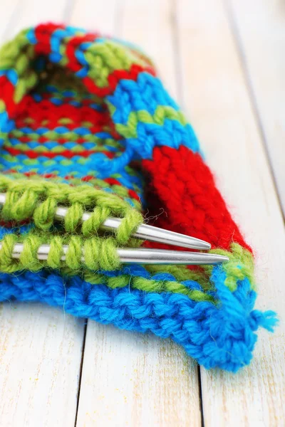 Knitting with spokes on wooden background — Stock Photo, Image