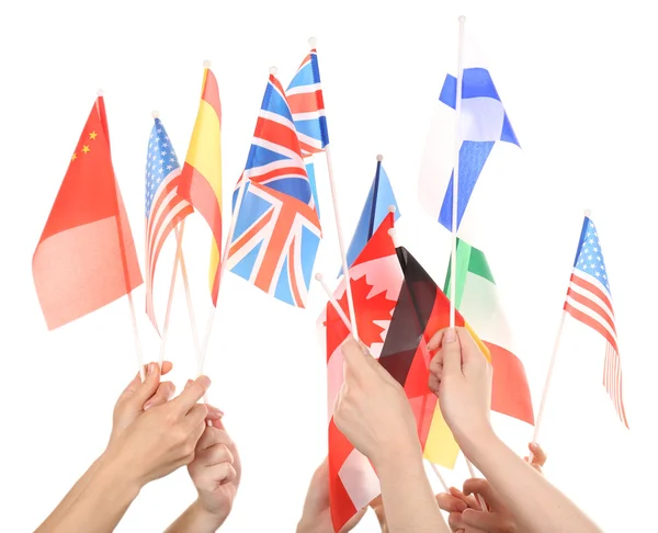 Hands holding different flags, isolated on white — Stock Photo, Image