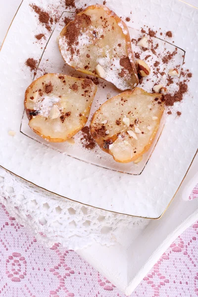 Baked pears with syrup on plate, on bright background — Stock Photo, Image