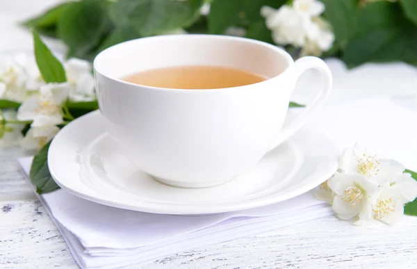 Cup of tea with jasmine on table close-up — Stock Photo, Image