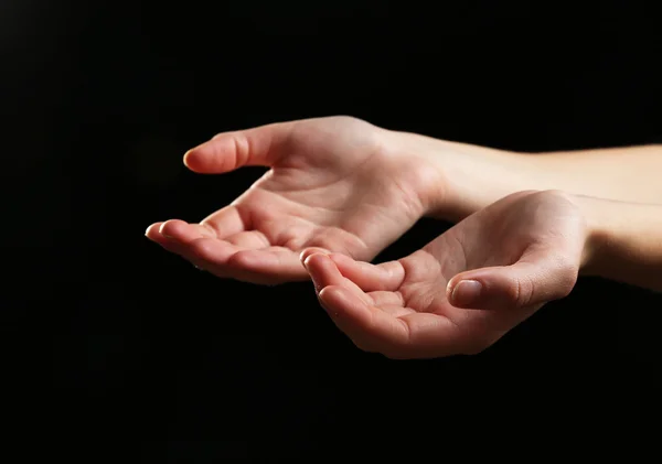 Human hands on black background — Stock Photo, Image