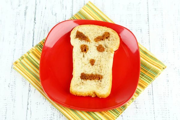 Funny toast, on color wooden background — Stock Photo, Image