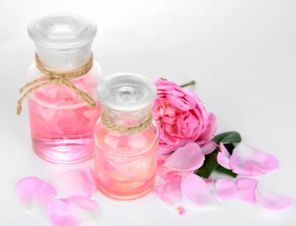 Rose oil in bottle isolated on white — Stock Photo, Image