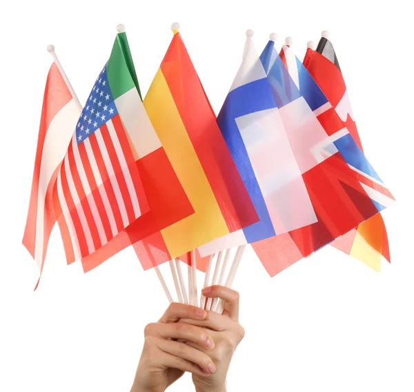 Hands holding different flags, isolated on white — Stock Photo, Image