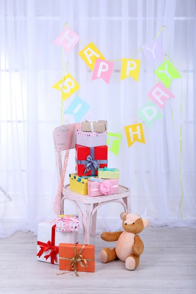 Many birthday gifts in room — Stock Photo, Image