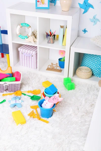 Colorful toys on fluffy carpet in children room — Stock Photo, Image