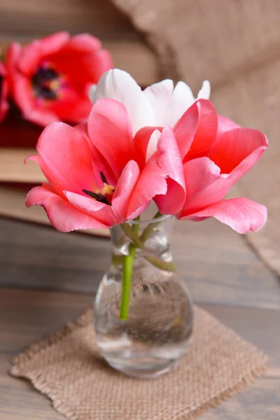 Beautiful tulips in bucket in vase on table on grey background — Stock Photo, Image