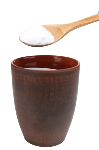 Spoon of baking soda over glass of water, isolated on white — Stock Photo, Image