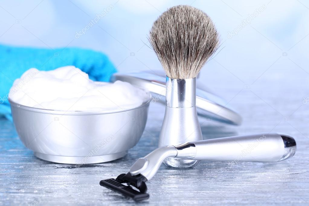 Male luxury shaving kit with towel on table on bright background