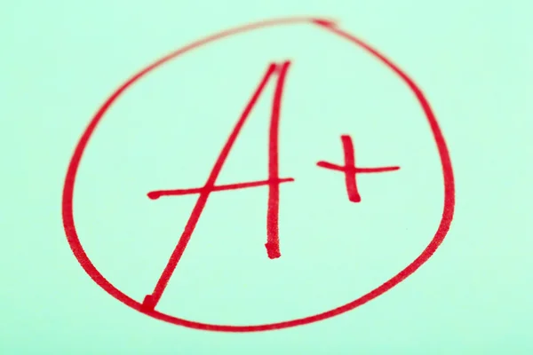 Grade A written on an exam paper — Stock Photo, Image