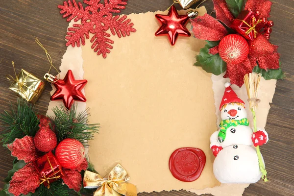 Frame with vintage paper and Christmas decorations on wooden background — Stock Photo, Image